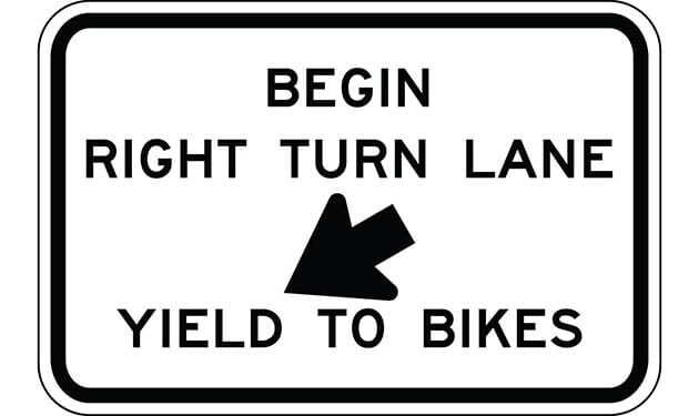 Begin Right Turn Lane Yield to Bikes with Down Arrow Sign The