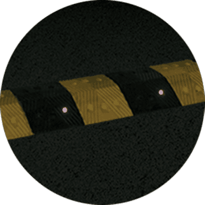TreeTop Speed Bump with reflectors at night” class=