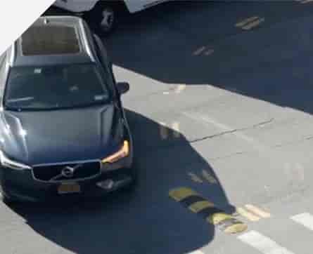 view looking down of grey car turning left